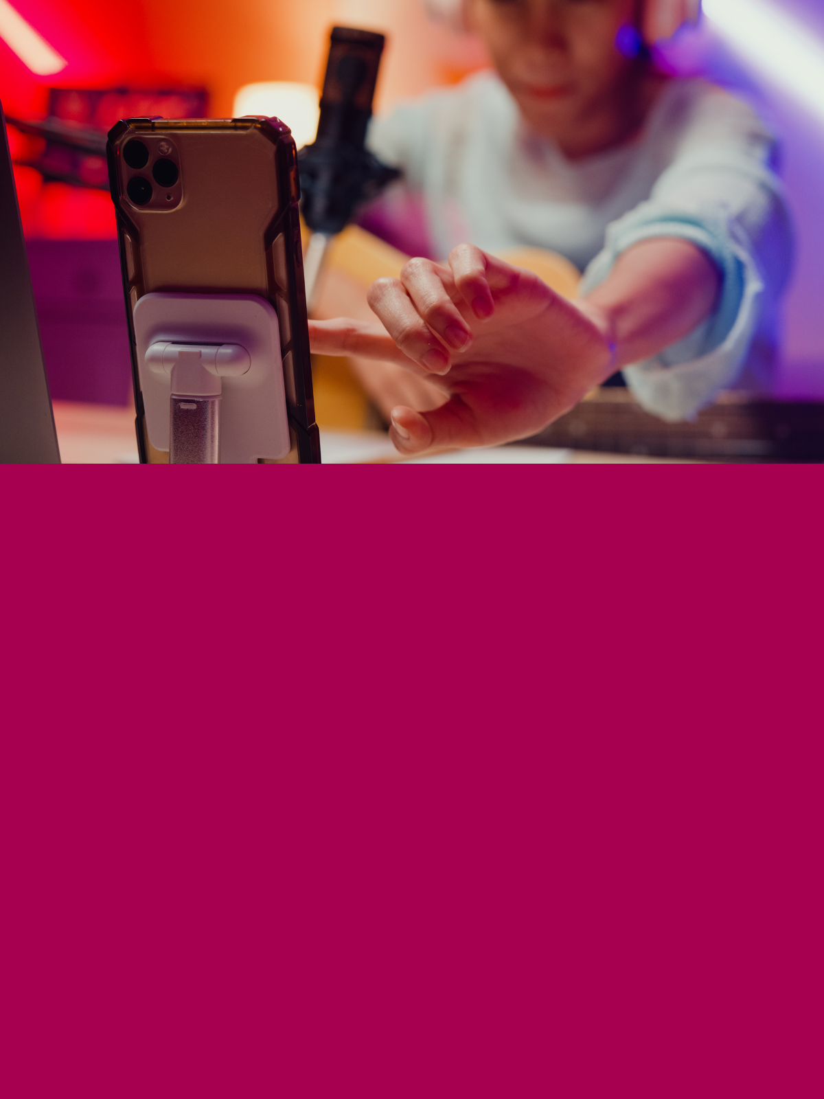 Image of person tapping smartphone in foreground with microphone in the background
