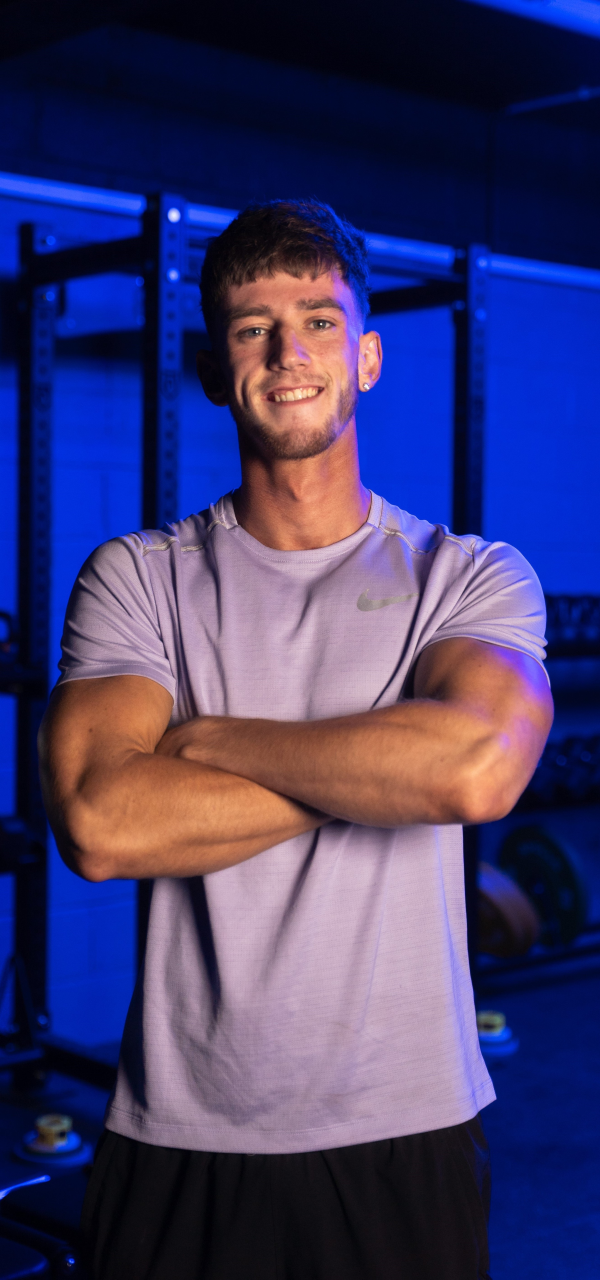 Student standing with arms folded