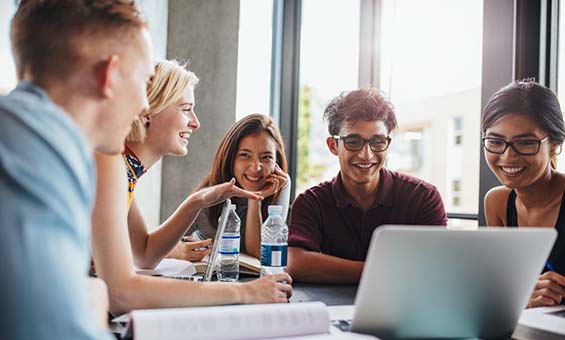 People chatting sitting around a laptop