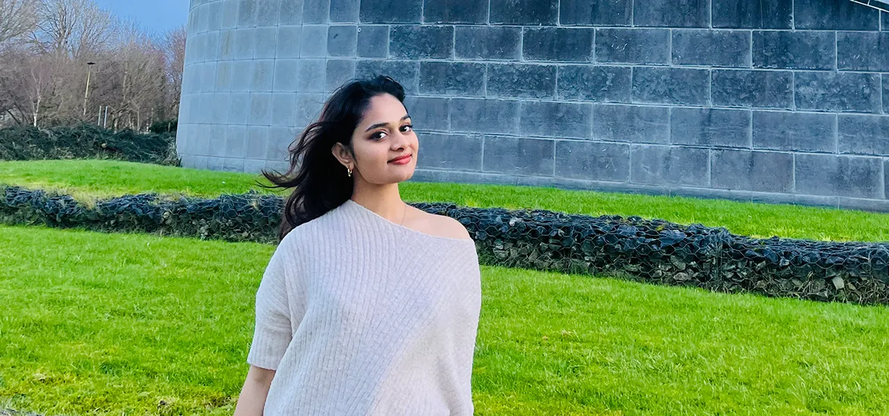 Image of a student in front of a building.
