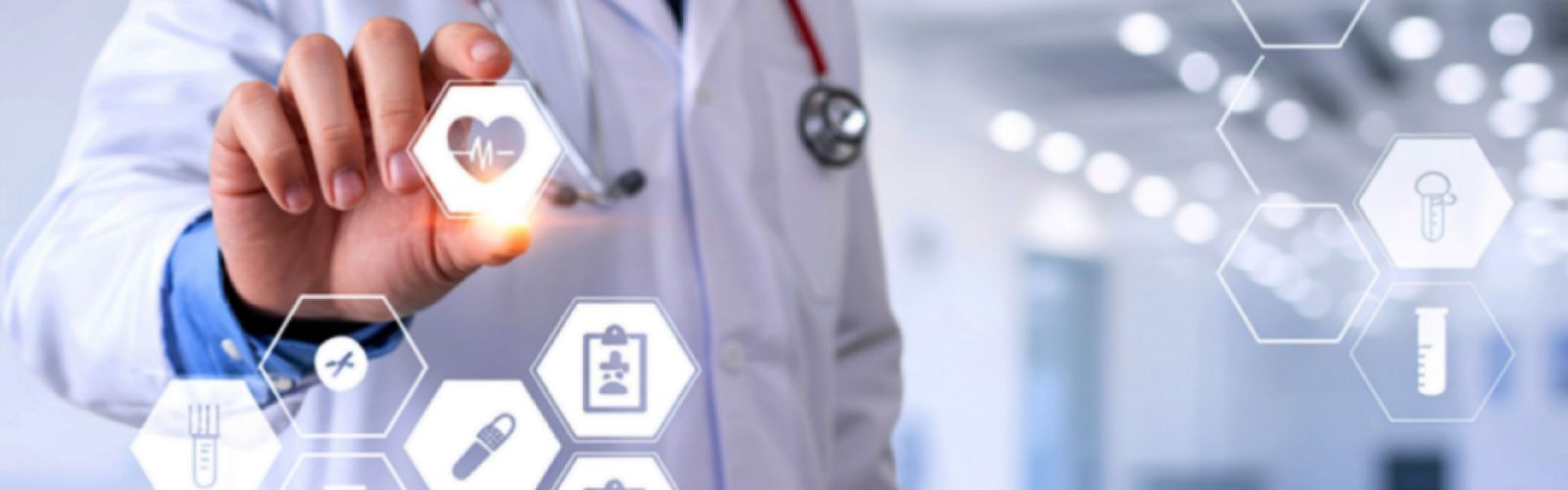 person in white medical gown, with tetiscope around their neck, pointing to medical device graphics in hexagonal shapes