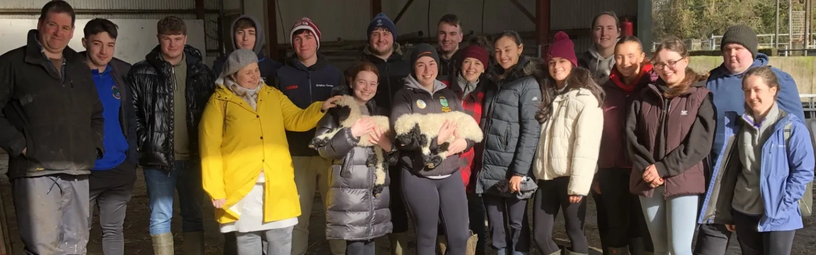 Students in Fieldtrip holding a sheep